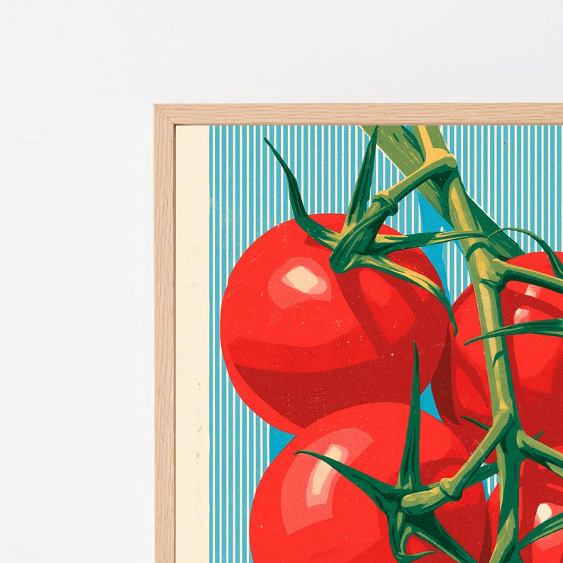 May include: A framed art print featuring a cluster of bright red tomatoes on a green vine. The background consists of vertical light blue and white stripes. The frame is made of light-coloured wood, providing a clean border to the illustration.