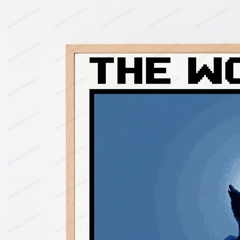 May include: A framed wall art print featuring a pixelated graphic of a wolf howling at a large, bright moon against a dark blue background. The text THE WO is visible at the top in a bold, black, pixelated font, encased in a light wood frame.