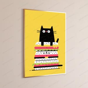 May include: A framed vertical wall art print featuring a black cat with wide eyes sitting atop a tall, multi-layered sandwich. The background is a solid bright yellow, and the sandwich consists of white bread, pink meat, and green lettuce layers.