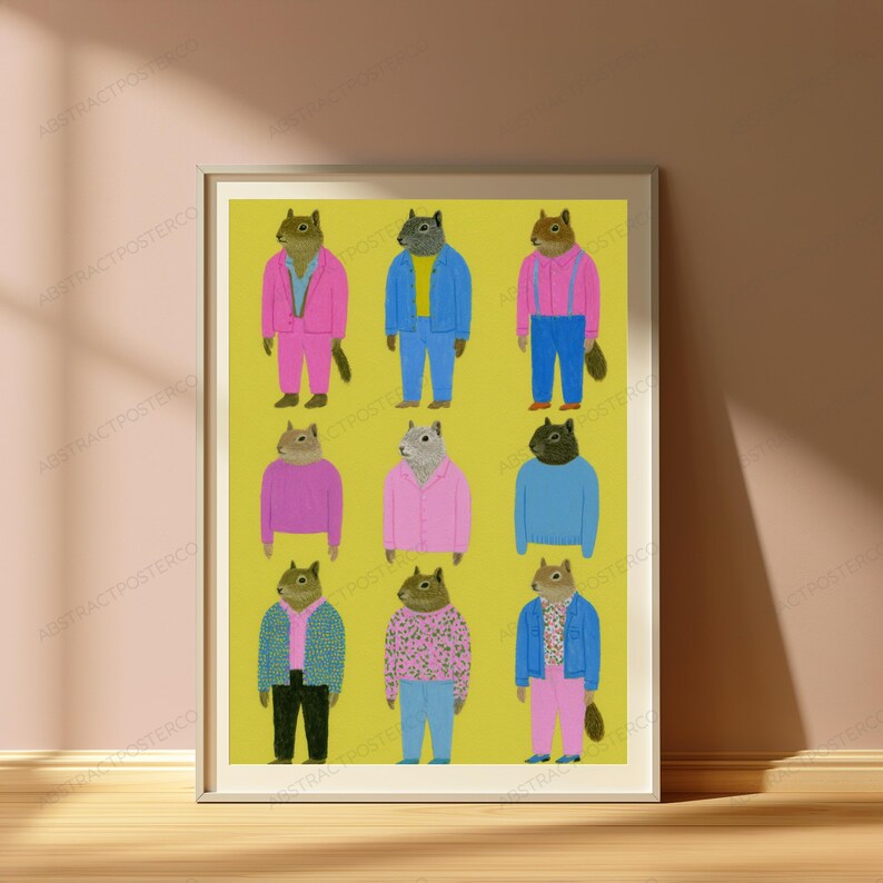 May include: A framed art print on a yellow background featuring nine illustrations of squirrels dressed in various colorful outfits, including pink suits, blue jackets, sweaters, and patterned shirts, arranged in a three-by-three grid pattern.