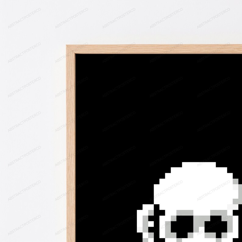 May include: A framed wall art piece featuring a pixelated white skull graphic set against a solid black background. The artwork is enclosed in a light-toned wooden frame with a clean, straight-edged profile, showcasing a high-contrast design.