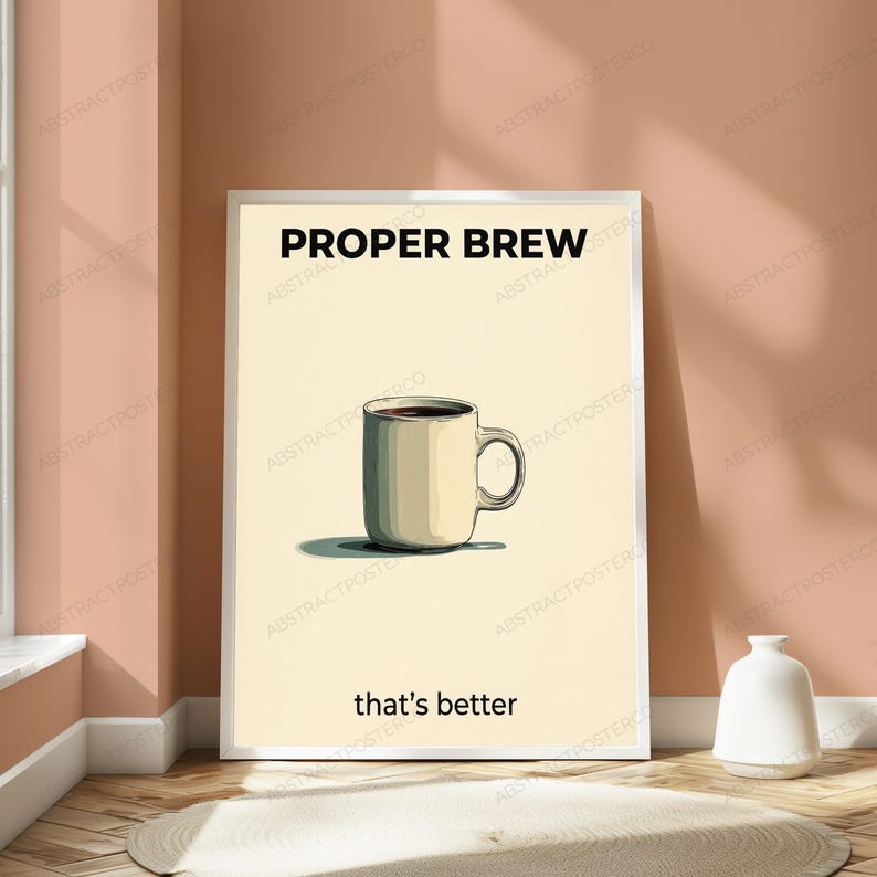 May include: A vertical rectangular poster in a white frame featuring a cream-colored background. Centered is a beige coffee mug filled with dark liquid. The text PROPER BREW appears in black at the top, and that's better is printed in black below.