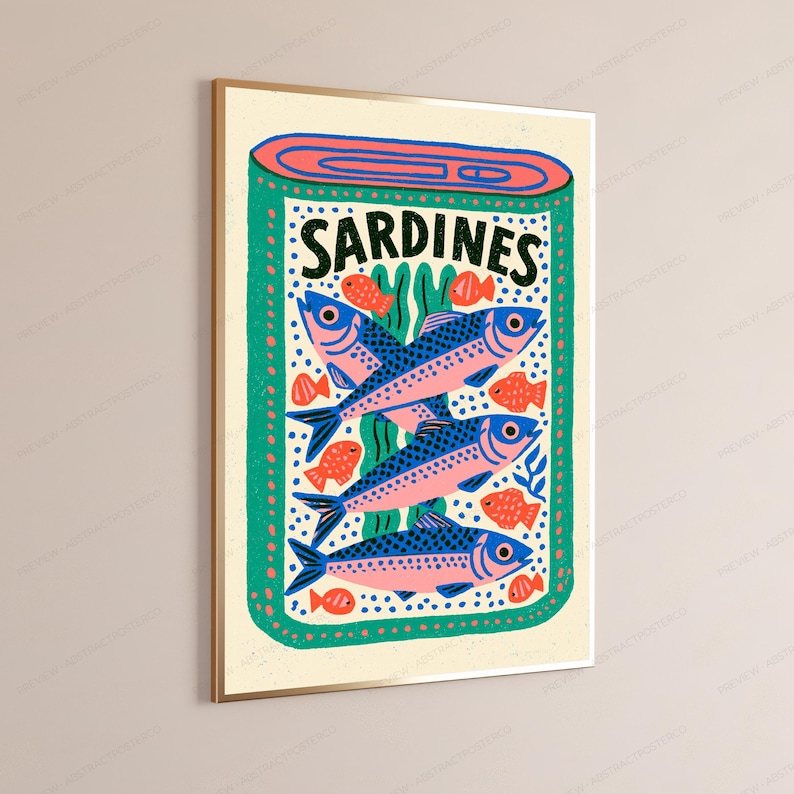 May include: A rectangular wall art print featuring a stylized illustration of an open tin of sardines. The design includes three large blue and pink fish, several smaller orange fish, and green seaweed accents on a cream background with the text SARDINES.