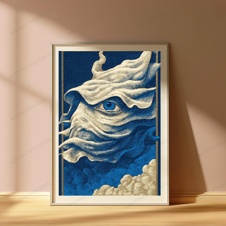 May include: A framed art print featuring a stylized illustration of a single blue eye emerging from swirling, cream-colored fabric-like clouds against a deep blue background, enclosed within a thin gold border and a simple light-colored frame.