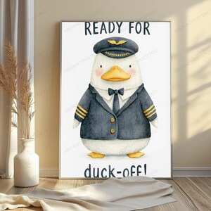 May include: A framed wall art print featuring a white duck dressed as a pilot in a dark blue uniform with gold stripes, a tie, and a captain's hat. The text READY FOR is printed above the duck, and the text duck-off! is printed below the duck.
