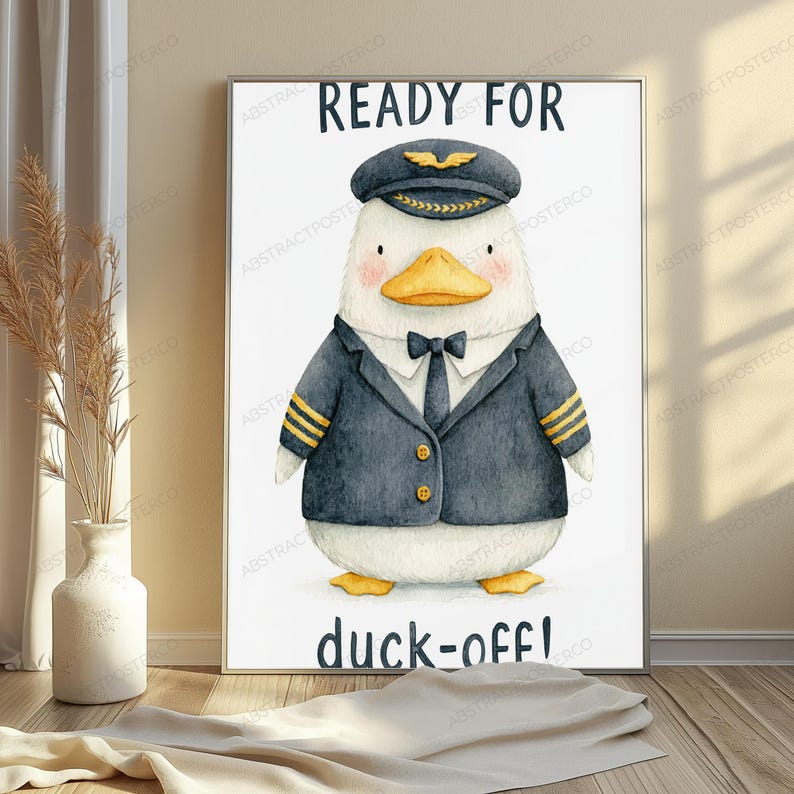 May include: A framed wall art print featuring a white duck dressed as a pilot in a dark blue uniform with gold stripes, a tie, and a captain's hat. The text READY FOR is printed above the duck, and the text duck-off! is printed below the duck.