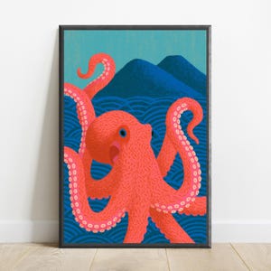 Puede incluir: Una l&aacute;mina art&iacute;stica enmarcada que muestra un pulpo de color rosa coral vibrante con un ojo azul, situado frente a olas oce&aacute;nicas estilizadas de color azul oscuro y dos picos monta&ntilde;osos azul oscuro sobre un cielo azul claro, en un marco negro.