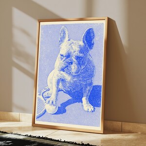 May include: A framed art print featuring a blue and white etched illustration of a French Bulldog sitting on a tennis court. The dog has one paw resting on a tennis ball, with a tennis racket visible nearby. The artwork has a textured, vintage style.