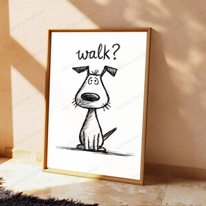 May include: A framed wall art print featuring a black ink sketch of a dog sitting down with the word walk? written above it in a handwritten font. The drawing has a sketchy, textured appearance on a plain white background within a wooden frame.