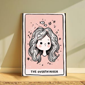 May include: A rectangular art print with a light pink background featuring a black line drawing of a person with wavy hair. Above the head are small drawings of two fish and stars. The text THE OVERTHINKER is printed in black at the bottom.