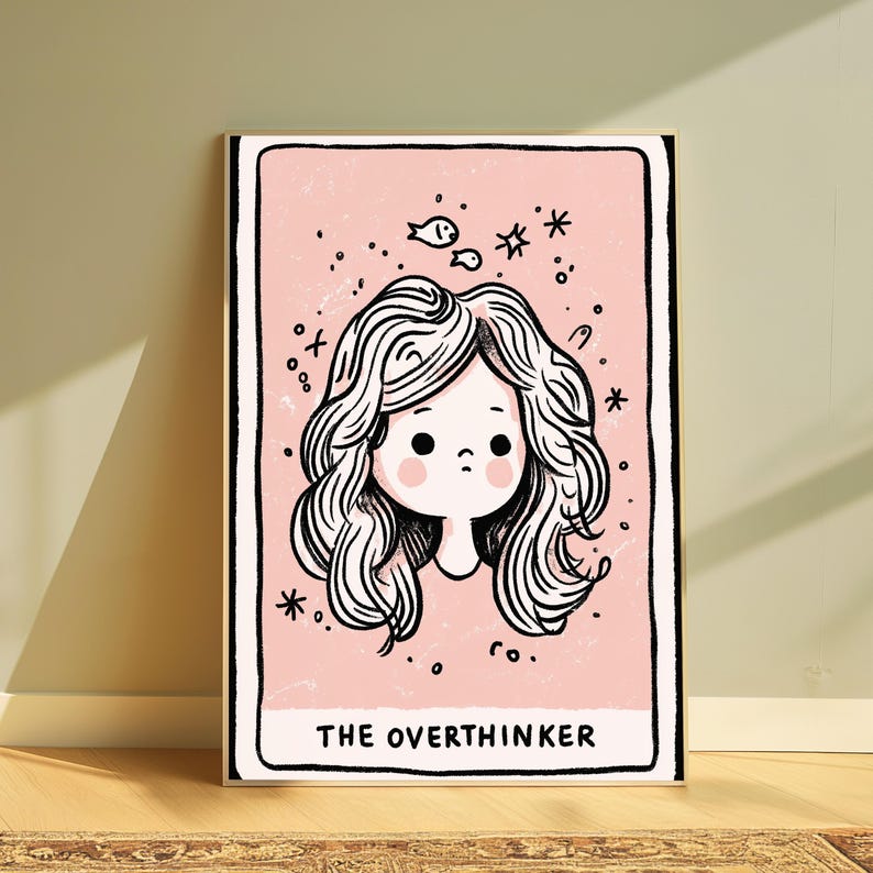 May include: A rectangular art print with a light pink background featuring a black line drawing of a person with wavy hair. Above the head are small drawings of two fish and stars. The text THE OVERTHINKER is printed in black at the bottom.