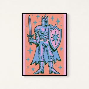 May include: A framed art print featuring a stylized illustration of a knight in armor holding a sword and a shield with a star emblem. The figure is rendered in shades of blue and pink against a coral background, surrounded by small star shapes.