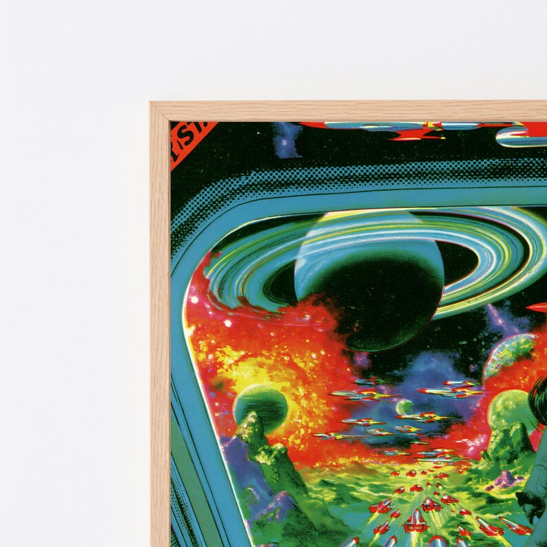 May include: A framed wall art print featuring a vibrant science fiction scene with a large ringed planet, glowing orange and yellow nebulae, and numerous small spacecraft flying over a green landscape. The artwork has a retro comic book aesthetic.