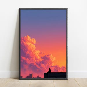 May include: A framed vertical wall art print featuring a silhouette of a person sitting on a rooftop against a vibrant sunset sky. The sky transitions from deep blue at the top to bright orange and pink hues, illuminated by large, fluffy clouds.