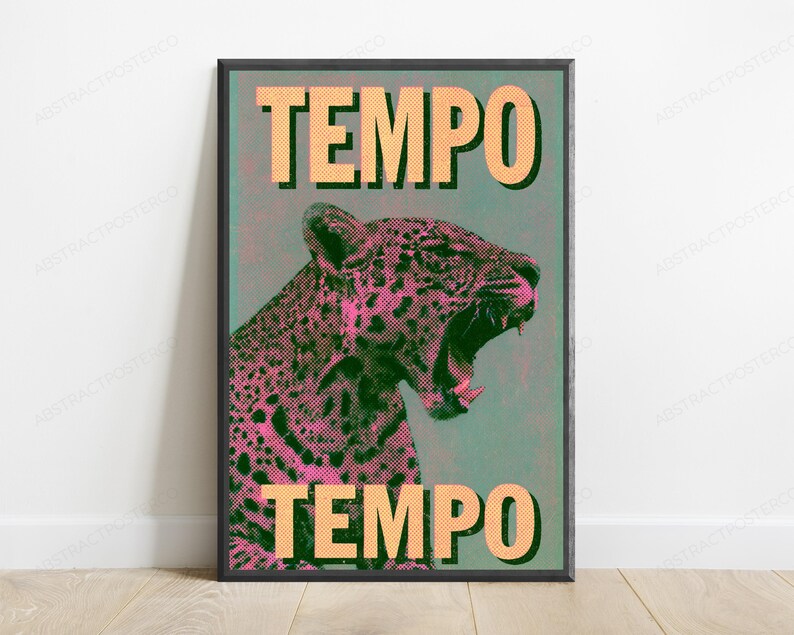 May include: A framed wall art print featuring a stylized leopard with pink and black halftone dot patterns against a muted teal background. The word TEMPO is printed in large, bold, light orange capital letters at both the top and bottom.