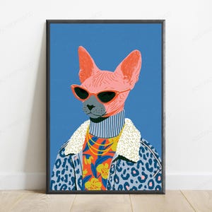 May include: A framed art print featuring a pink Sphynx cat wearing red cat-eye sunglasses, a grey turtleneck, a gold chain, and a blue leopard print jacket with a white sherpa collar, set against a solid blue background with a subtle texture.