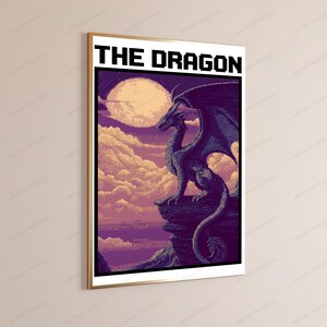 May include: A framed pixel art poster titled THE DRAGON, featuring a dark purple dragon perched on a rocky cliff against a backdrop of soft clouds and a large, pale yellow moon. The artwork uses a distinct blocky, digital aesthetic style.