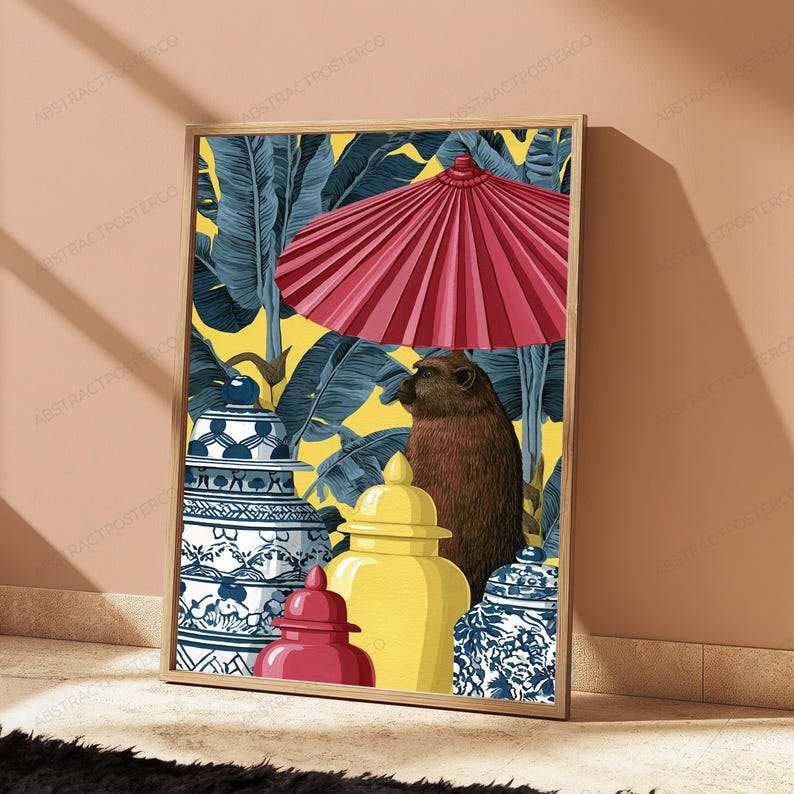 May include: A framed wall art print featuring a brown monkey standing under a large red parasol. The scene includes two blue and white patterned ginger jars and one solid yellow ginger jar against a background of dark blue tropical banana leaves.