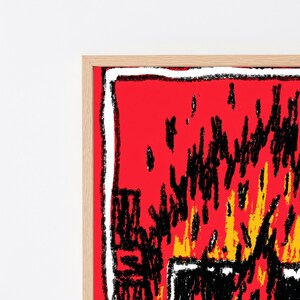 May include: A framed wall art piece featuring a vibrant red background with a stylized, hand-drawn illustration of flames in black and yellow. The artwork is enclosed within a light-colored wooden frame, showcasing a bold, textured graphic design.