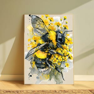 May include: A rectangular wall art print featuring a watercolor illustration of a fuzzy bumblebee with black and yellow stripes. The bee is surrounded by clusters of small, vibrant yellow flowers and abstract grey and yellow paint splatters.