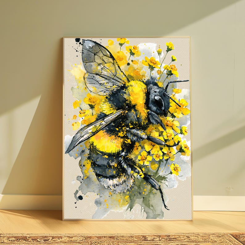 May include: A rectangular wall art print featuring a watercolor illustration of a fuzzy bumblebee with black and yellow stripes. The bee is surrounded by clusters of small, vibrant yellow flowers and abstract grey and yellow paint splatters.