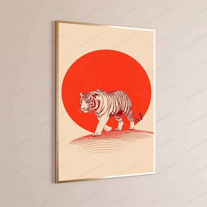 May include: A framed wall art print featuring a tiger illustration in dark red lines walking across a curved surface. Behind the tiger is a large, solid red circle set against a light beige background, enclosed in a thin gold-coloured frame.