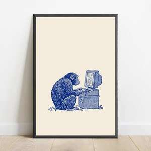 May include: A framed art print featuring a blue ink illustration of a chimpanzee sitting at a vintage computer desk and typing on a keyboard. The artwork is set against a solid cream-colored background, enclosed within a simple black frame.