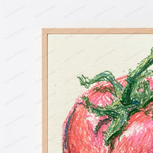 May include: A framed wall art print featuring a textured oil pastel drawing of a red tomato with a green stem and leaves. The artwork is set against a cream-colored background and enclosed within a light-toned wooden frame.