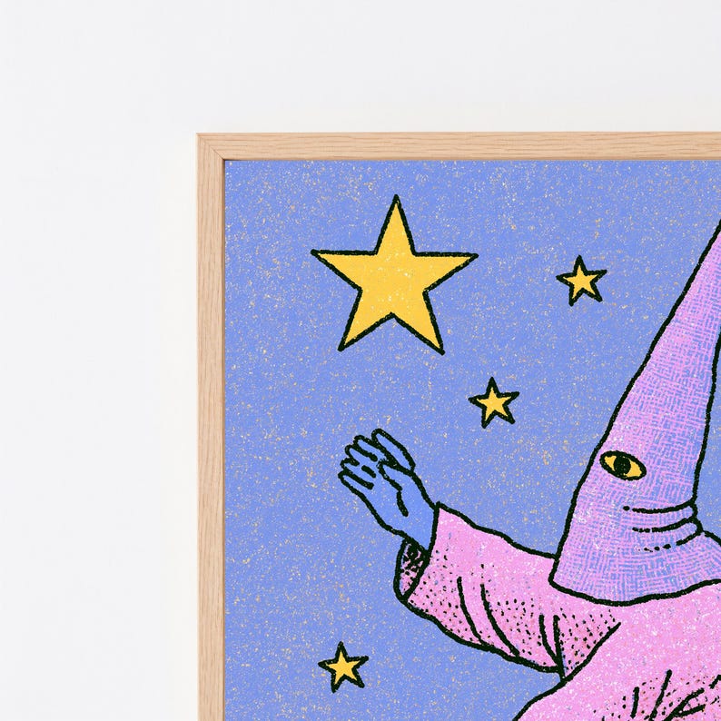 May include: A framed art print featuring a blue background with a textured, speckled surface. A figure wearing a pink pointed hood and robe reaches toward several yellow stars. The figure has a single visible eye on the hood and blue skin.