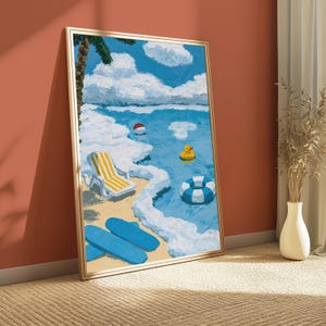 May include: A framed oil painting depicting a sunny beach scene with a yellow and white striped lounge chair, a blue and white striped inner tube, a yellow rubber duck, a red and white ball, and two blue surfboards on the sandy shore.