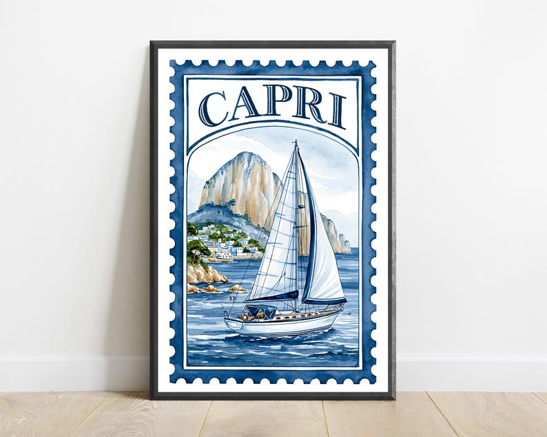 May include: A framed wall art print designed like a postage stamp featuring a watercolor illustration of a sailboat on blue water with a rocky cliffside and white buildings in the background. The word CAPRI is printed in dark blue at the top.