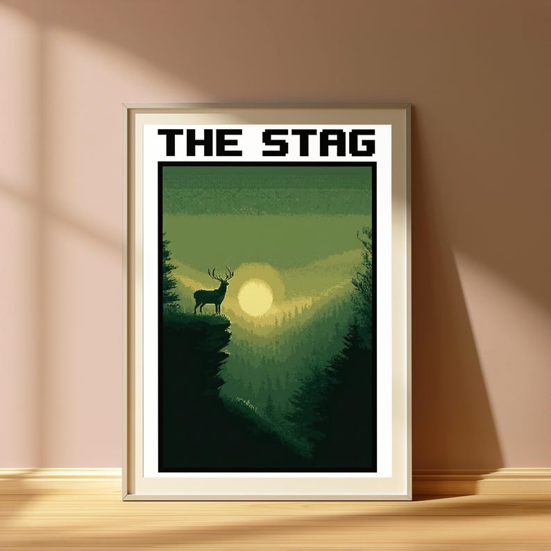 May include: A framed rectangular wall art print featuring a pixel art landscape in shades of green. The image depicts a stag standing on a cliff edge overlooking a forest valley with a pale yellow sun. The text THE STAG is printed in black.