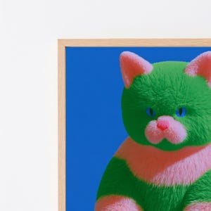 May include: A framed wall art print featuring a fluffy cat with vibrant green fur, a pink muzzle, and bright blue eyes. The cat is set against a solid, deep blue background. The artwork is enclosed in a light-colored wooden frame.