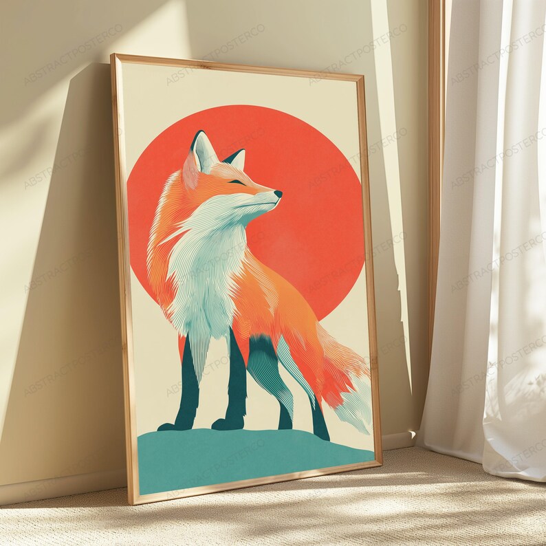 May include: A rectangular framed wall art print featuring a stylised illustration of a fox with orange and white fur standing on a teal ground. Behind the fox is a large solid red circle set against a light cream background within a wooden frame.