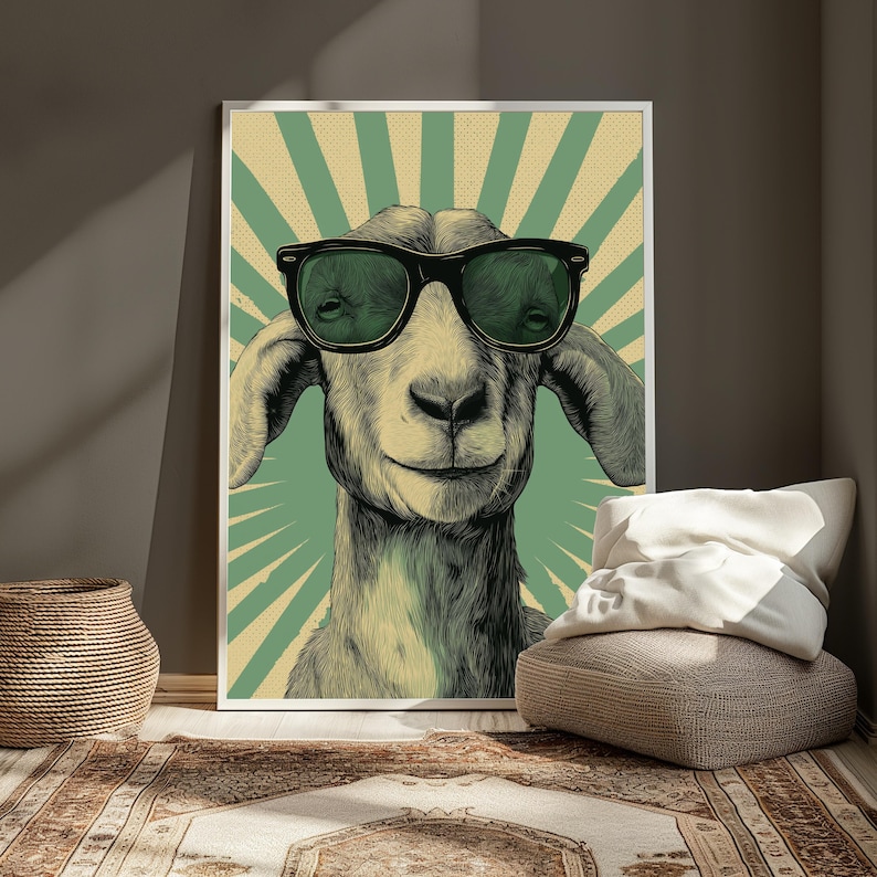 May include: A rectangular wall art print featuring a detailed illustration of a goat wearing large black-rimmed sunglasses. The background consists of a vintage-style sunburst pattern in alternating shades of muted green and cream with a dotted texture.
