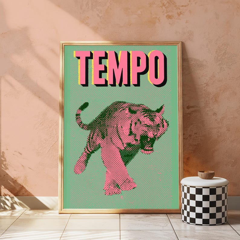 May include: A rectangular framed wall art print featuring a light green background with a halftone pink tiger illustration in the center. The word TEMPO is printed in large, bold pink letters with a black drop shadow at the top of the print.