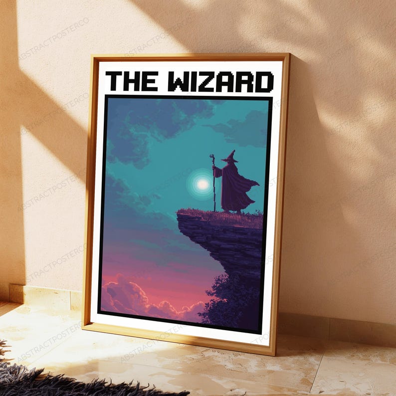 May include: A framed poster titled THE WIZARD in pixelated black font. The artwork depicts a dark silhouette of a robed figure with a pointed hat and staff standing on a cliff edge against a teal sky with a bright moon and pink clouds below.