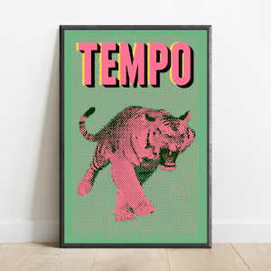 May include: A framed wall art print featuring a pink tiger illustration with a black halftone dot pattern on a light green background. The word TEMPO is printed in large pink capital letters with a black drop shadow at the top of the artwork.