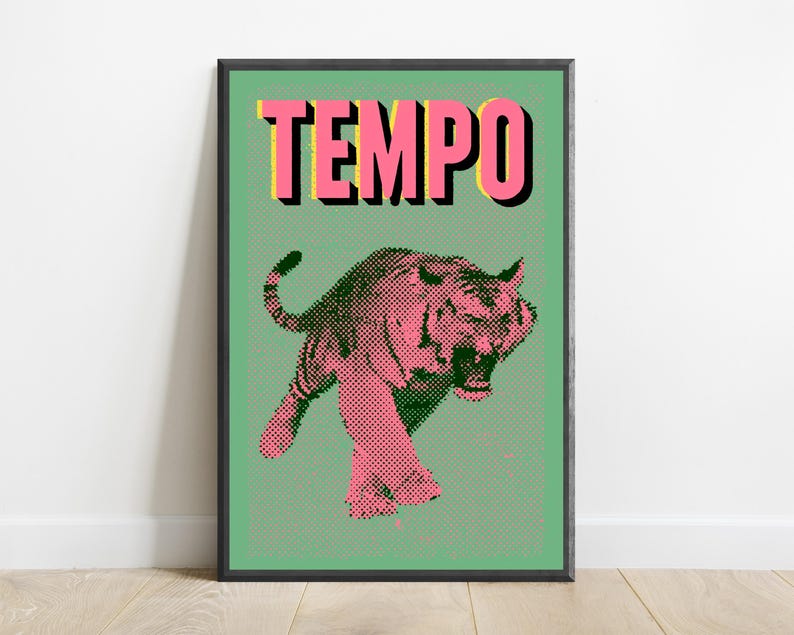 May include: A framed wall art print featuring a pink tiger illustration with a black halftone dot pattern on a light green background. The word TEMPO is printed in large pink capital letters with a black drop shadow at the top of the artwork.