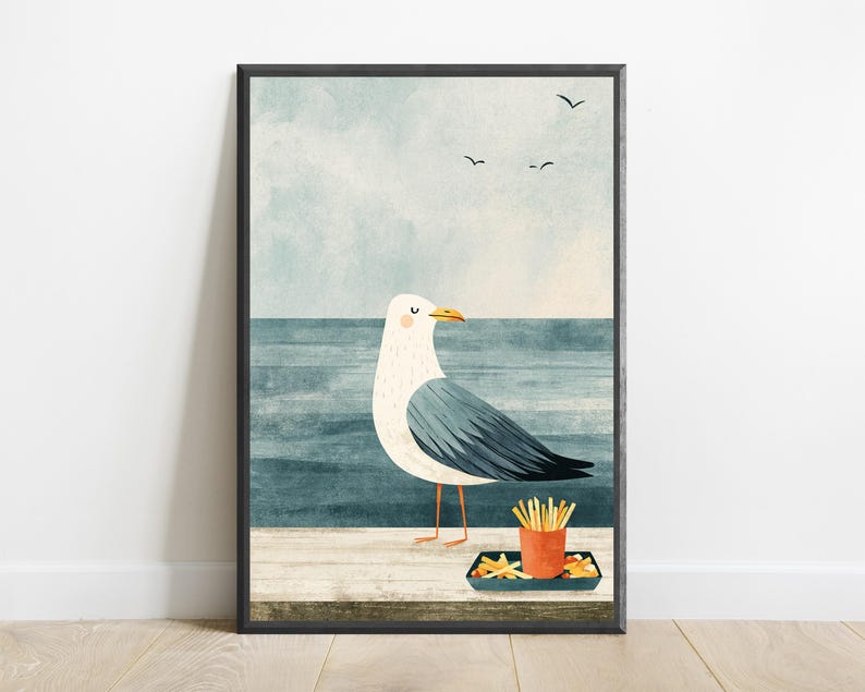 May include: A framed wall art print featuring a white and gray seagull standing on a wooden pier. The bird is positioned next to a small orange container filled with french fries. The background shows a blue ocean and a pale sky with birds.