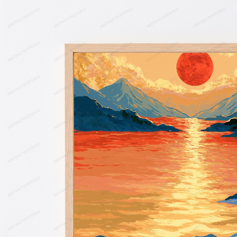 May include: A framed wall art print featuring a landscape illustration with a large red sun setting over a body of water. The scene includes dark blue mountain silhouettes, golden yellow reflections on the water, and orange clouds in the sky.