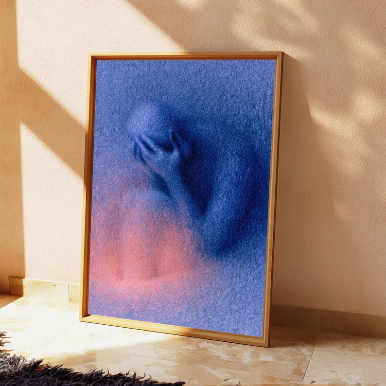 May include: A framed rectangular wall art piece featuring a textured blue figure in a seated, head-in-hands pose. The figure is composed of dense, scribbled lines, with a soft, glowing pink light emanating from the lower portion of the composition.