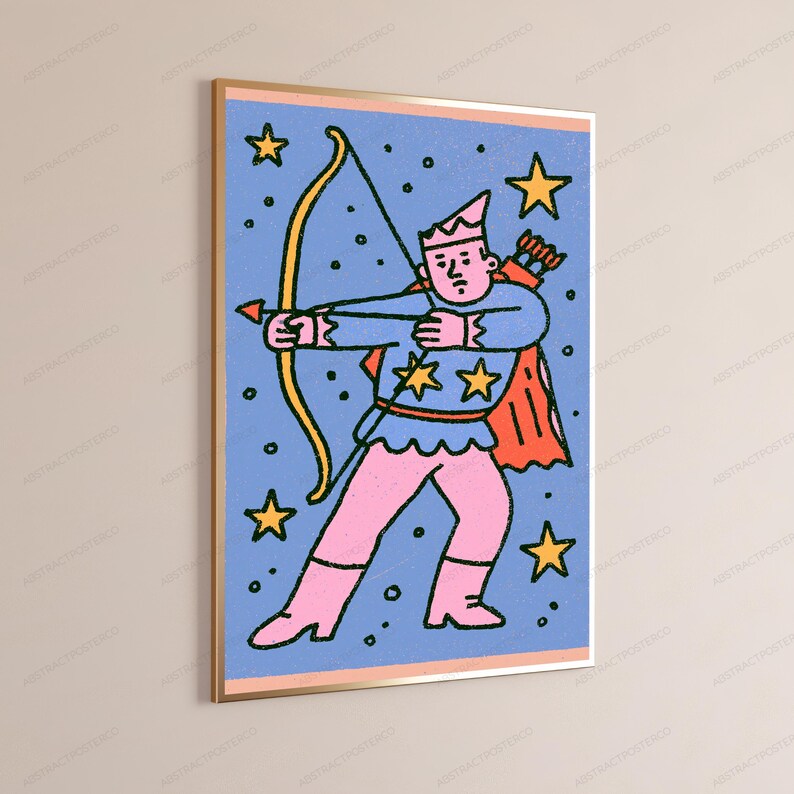 May include: A framed wall art print featuring a stylized illustration of a figure in a crown and cape holding a yellow bow and arrow. The character wears a blue top with yellow stars and pink pants against a blue background with yellow stars.