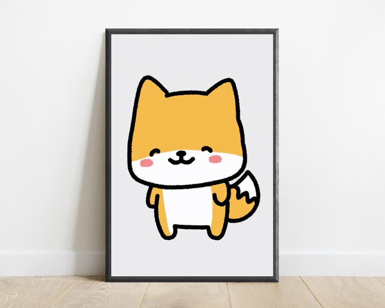 May include: A framed wall art print featuring a cartoon illustration of a small orange and white fox with a thick black outline. The fox has a smiling expression, pink cheeks, and a bushy tail, set against a plain light gray background.
