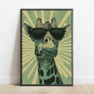 May include: A framed wall art print featuring a stylized illustration of a giraffe wearing black sunglasses. The giraffe has a green and black spotted pattern, set against a background of radiating light green and beige sunburst lines.