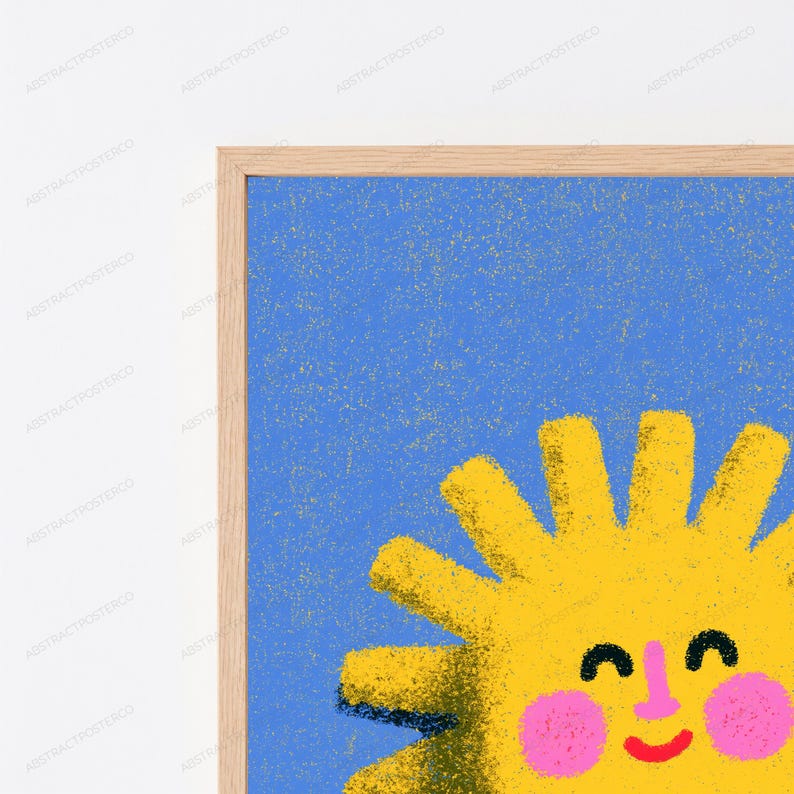 May include: A framed wall art print featuring a stylised yellow sun with a smiling face, pink cheeks, and a pink nose against a textured blue background. The sun has multiple radiating rays and a grainy, speckled artistic finish throughout the design.