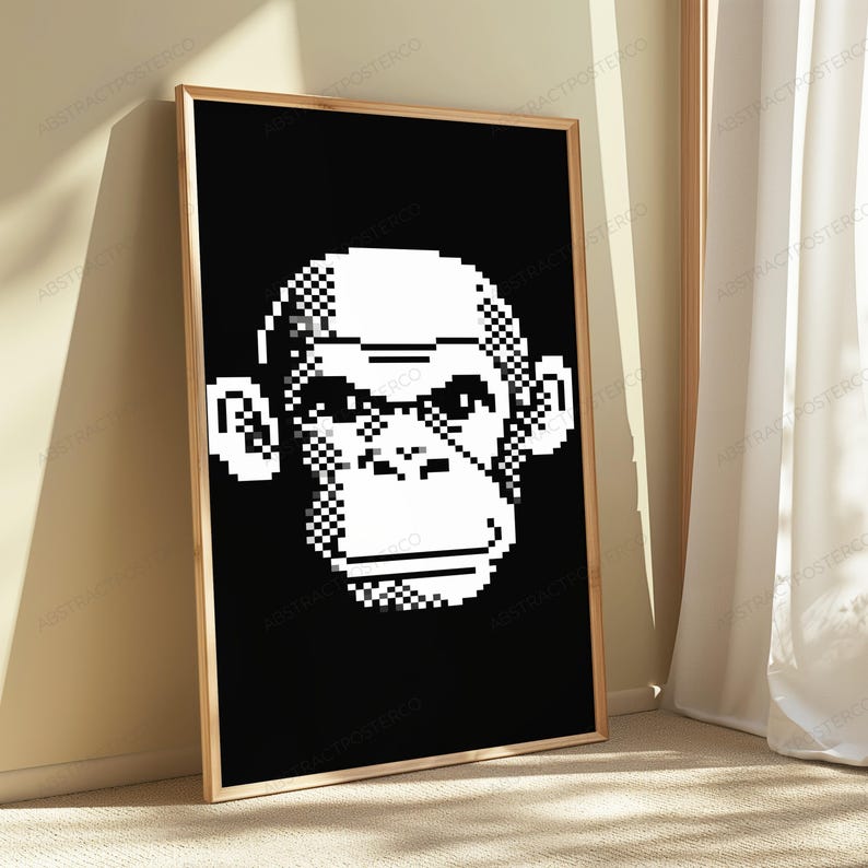 May include: A rectangular framed wall art piece featuring a high-contrast, black and white pixel art illustration of a chimpanzee face. The design uses a grid-based aesthetic to define the facial features, ears, and head shape against a solid black background.