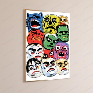 May include: A rectangular wall art print in a thin gold frame featuring a colorful pop art collage of various monster and creature faces in blue, red, yellow, green, and purple hues with bold black outlines and a distinct comic book dot texture.