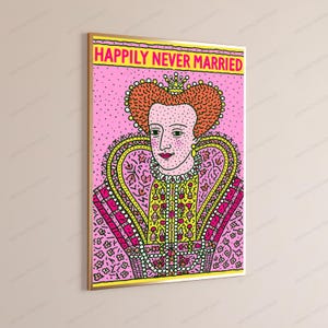 May include: A framed wall art print featuring a stylized illustration of a monarch with a crown and elaborate collar. The background is pink with black dots, and the text "HAPPILY NEVER MARRIED" is printed in bold yellow letters at the top.