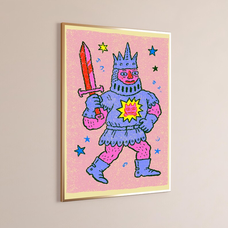 May include: A framed wall art print featuring a stylized illustration of a knight in blue armor and a crown, holding a red sword. The figure has pink skin and is set against a textured pink background with yellow and blue stars and a yellow sun emblem.